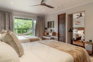 a bedroom with two beds and a window at Hotel Alto Monte Hacienda & Spa - Only Adults in Chiguirí Arriba