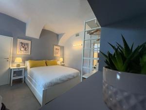 a bedroom with a bed and a table with a plant at Dimora Federica in Erbusco +71 photos