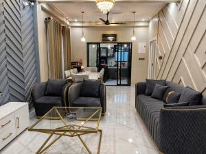a living room with two couches and a table at Villa Grazia 99 in Katuneriya +46 photos