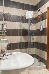 a bathroom with a shower and a tub and a sink at Arcobaleno Rooms in Cagliari +50 photos