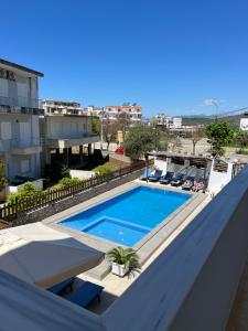 a swimming pool on the roof of a building at Hotel Villa Ruci in Ksamil