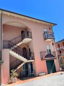 a building with stairs and balconies on it at Hotel Anita B&B sul lungomare in Gatteo a Mare