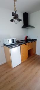 a kitchen with a stove and a white refrigerator at Ninho da Avó Selvagem in Montalegre +39 photos