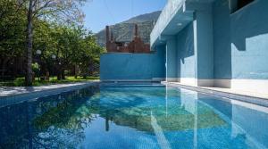 a swimming pool in a villa with a blue wall at Riad Rêve D'Ourika in Ourika +45 photos