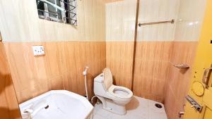 a small bathroom with a toilet and a sink at Epindi Studio Apartment in Cox's Bazar