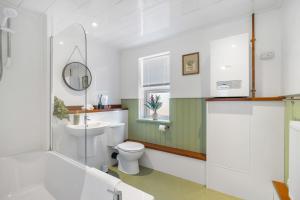 a bathroom with a toilet and a sink at Spacious 2-Bed Eastbourne Retreat in Eastbourne +19 photos