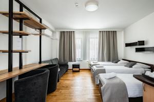 a hotel room with two beds and chairs at Restauracja Sonata in Zwierzyniec +41 photos