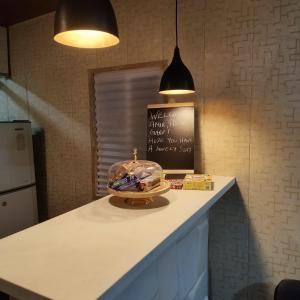 a kitchen counter with a cake on top of it at OrchardNest in Moinabad +5 photos