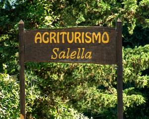 a sign that reads antiquatio saliba in front of trees at Agriturismo Salella in Salento