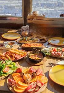 a table with many plates of food on it at Uchisar Cave House in Uçhisar +38 photos