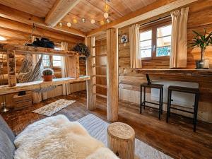 a living room with a couch and a fireplace in a log cabin at WoodMood in Leuk