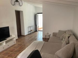 a living room with a couch and a tv at Casa Tomas in Albox