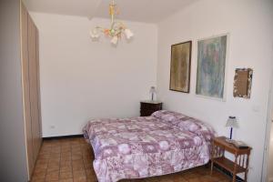 a bedroom with a bed and a table with a lamp at Il Castello di Scoffera in Moranego