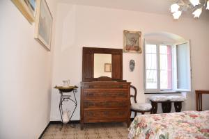 a bedroom with a bed and a dresser and a mirror at Il Castello di Scoffera in Moranego +67 photos
