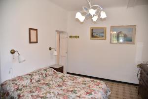 a bedroom with a bed and two pictures on the wall at Il Castello di Scoffera in Moranego