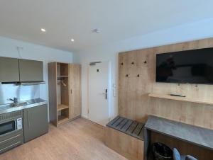 a kitchen with a large tv on the wall at Hotel zur Erholung in Buxtehude