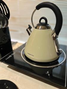 a tea kettle sitting on top of a stove at Greyton Stay in Greyton