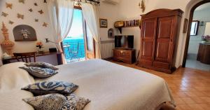 a bedroom with two beds and a view of the ocean at La dimora degli Dei in Praiano