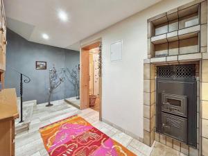 a kitchen with a stove and a rug on the floor at Haus Farbenklang in Zwiesel