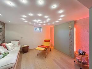 a room with a bed and a yellow chair at Haus Farbenklang in Zwiesel