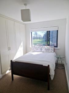 a bedroom with a large bed and a window at Parochial View in Athboy