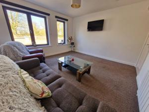 a living room with a couch and a coffee table at Parochial View in Athboy