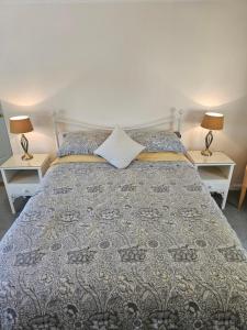 a bedroom with a large bed with two night stands at The Martins B&B in Chelsworth