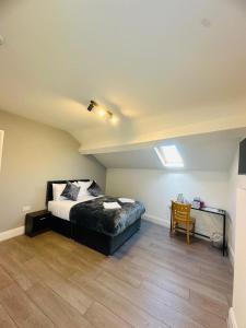 a bedroom with a bed and a wooden floor at Melrose Abbey Guest House in Liverpool
