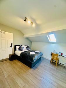 a bedroom with a bed and a ceiling with a window at Melrose Abbey Guest House in Liverpool +7 photos