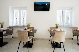 a dining room with two tables and chairs at Villa Rossa in Agerola