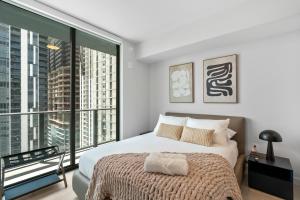 a bedroom with a bed and a large window at Prime Downtown Condo with City Views in Miami