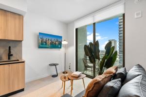 a living room with a couch and a large window at Prime Downtown Condo with City Views in Miami
