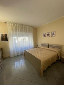 a bedroom with a bed and a large window at maison du cinemà in Turin