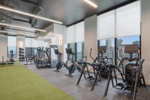 a gym with treadmills and elliptical machines at Prime Downtown Condo with City Views in Miami