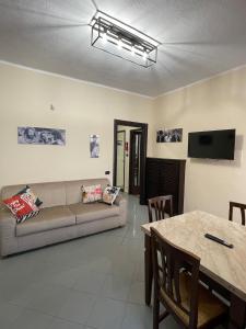 a living room with a couch and a table at maison du cinemà in Turin