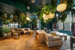 a lobby with tables and chairs and plants at Prime Downtown Condo with City Views in Miami +56 photos