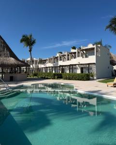 a swimming pool in front of a house at VR CLUB Tulum Riviera in Tulum