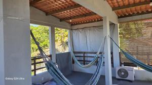 a hammock on the porch of a house at Apartamento com Terraço na Gamboa do Morro in Cairu +19 photos