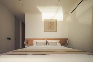 a bedroom with a large bed with two pillows at Dia Dyo Residences in Pefki +65 photos