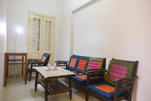 a room with chairs and a table and a table and chairs at Maison Vy Homestay in Hue