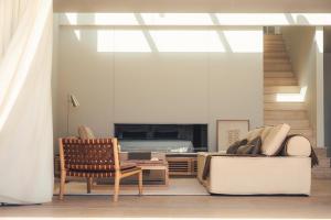 a living room with a bed and a chair at Dia Dyo Residences in Pefki