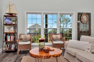 a living room with a couch and chairs and a table at Bethany Cottage by Pristine Properties Vacation Rentals in Indian Pass
