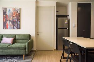 a living room with a green couch and a table at Chic Providencia Apt 2BR 2BA Sleeps 5 in Santiago