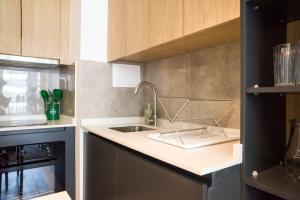 a kitchen with a sink and a dish rack on the counter at Chic Providencia Apt 2BR 2BA Sleeps 5 in Santiago +33 photos