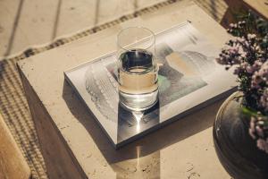a picture of a wine glass on a table at Dia Dyo Residences in Pefki