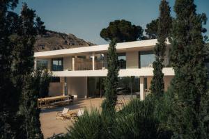 a modern house with trees in front of it at Dia Dyo Residences in Pefki