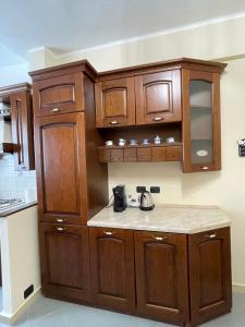 a kitchen with wooden cabinets and a counter top at maison du cinemà in Turin +32 photos