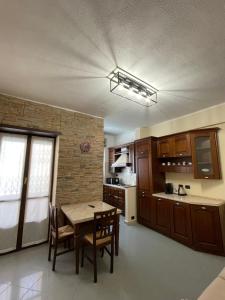 a kitchen with a table and chairs in a room at maison du cinemà in Turin