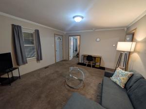 a living room with a couch and a table at 2-bedroom house close to Marathon in Robinson