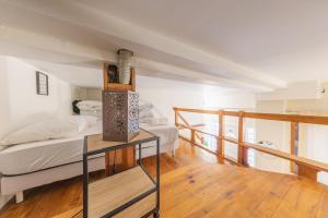 a bedroom with a bed and a balcony at Urban Nest in Sevran